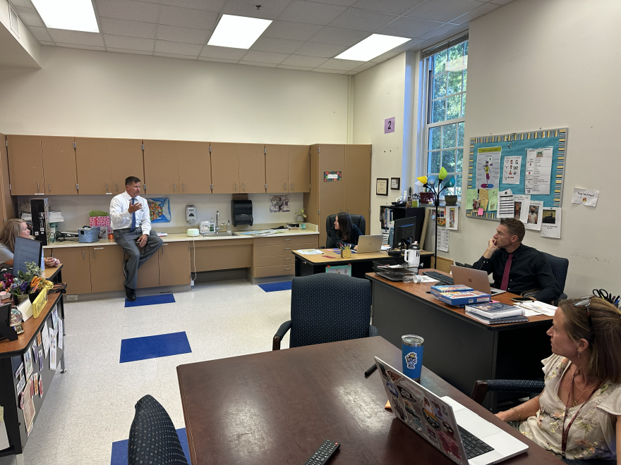 Lehocky is speaking with his administrative and instructional support staff.