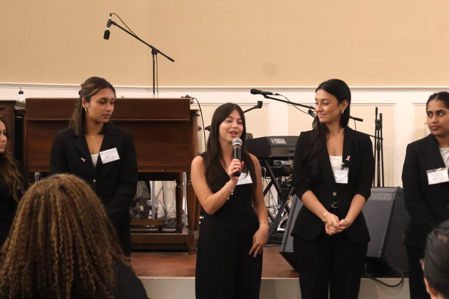 Health disparities and health promotion interns introduce themselves to attendees during the UF Health Cancer Institute's cancer disparities research showcase on Thursday, Oct. 22, 2026. (Emilia Hueller/WUFT News)