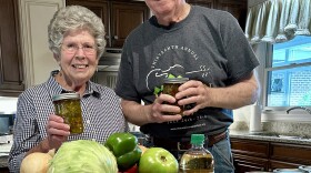 Kay Wade in her kitchen showcasing her homemade chow-chow 