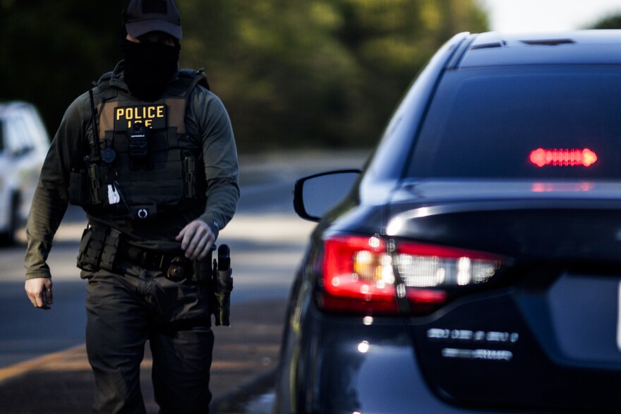 An ICE agent makes their way back to their car after making a stop near Southwood on Wednesday, April 8, 2026 in Richmond, Virginia.