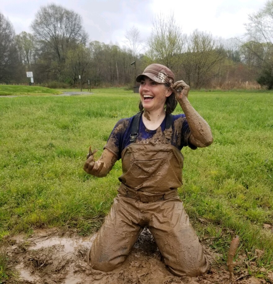 Bronwyn Williams digging for crayfish in Huntersville, North Carolina. Williams is one of the lead principal investigators for the new research project. Photograph by Michael A. Perkins.