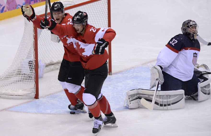 Canada's Jamie Benn (right) and Corey Perry celebrate a goal against America and goalie Jonathan Quick during the men's hockey semifinals in Sochi Friday.