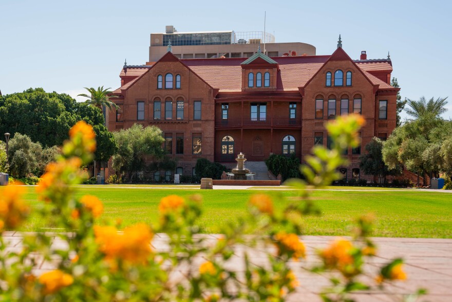 Arizona State University's campus with a green field and yellow flowers. 
