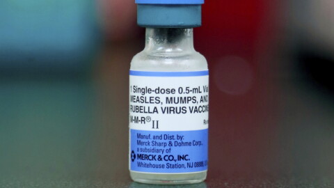 FILE - This Friday, May 17, 2019 file photo shows a vial of a measles, mumps and rubella vaccine in Mount Vernon, Ohio. On Thursday, Aug. 29, 2019, the first U.S. government report on mumps in migrant detention facilities say the virus has spread through 57 facilities in 19 states since September with new cases continuing as detainees are taken into custody or transferred. (AP Photo/Paul Vernon)