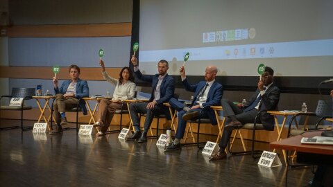 From left to right, candidates Nate Blouin, Eva Lopez Chavez, Michael Farrell, Derek Kitchen and Liban Mohamad show their opinion on political issues with a yes/no paddle at the beginning of a March 9, 2026, town hall organized by the 71 Percent Coalition and the Utah Chapter of Black Lives Matter.