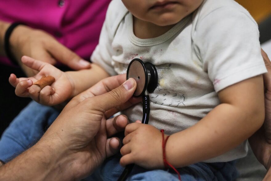 A doctor's hand examines a 16-month-old boy 