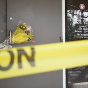 Caution tape and flowers cover the entrance to the Beth Israel Congregation, a synagogue that was set on fire early Saturday morning, on Monday, Jan. 12, 2026, in Jackson, Miss. 
