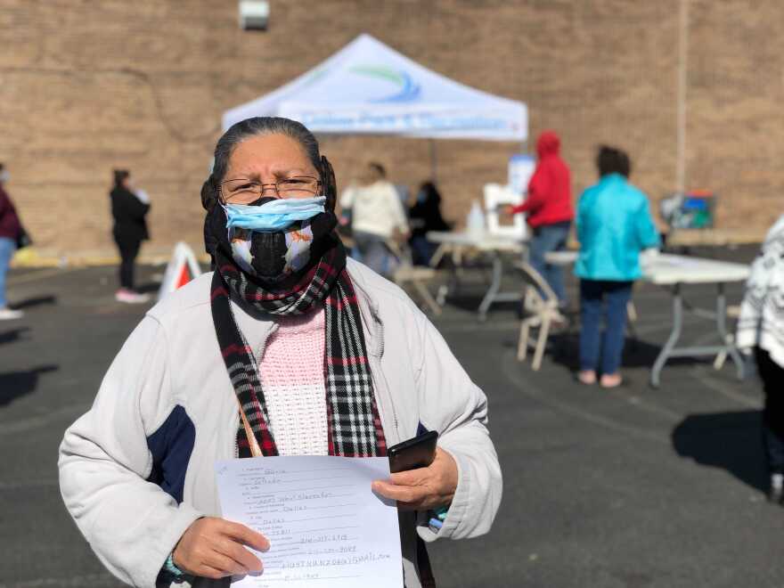 Gloria Núñez Estrada fills out the COVID-19 vaccination paperwork, at a supermarket parking lot in Oak Cliff with help from community volunteers who helped translatiing, on Feb. 3, 2021.