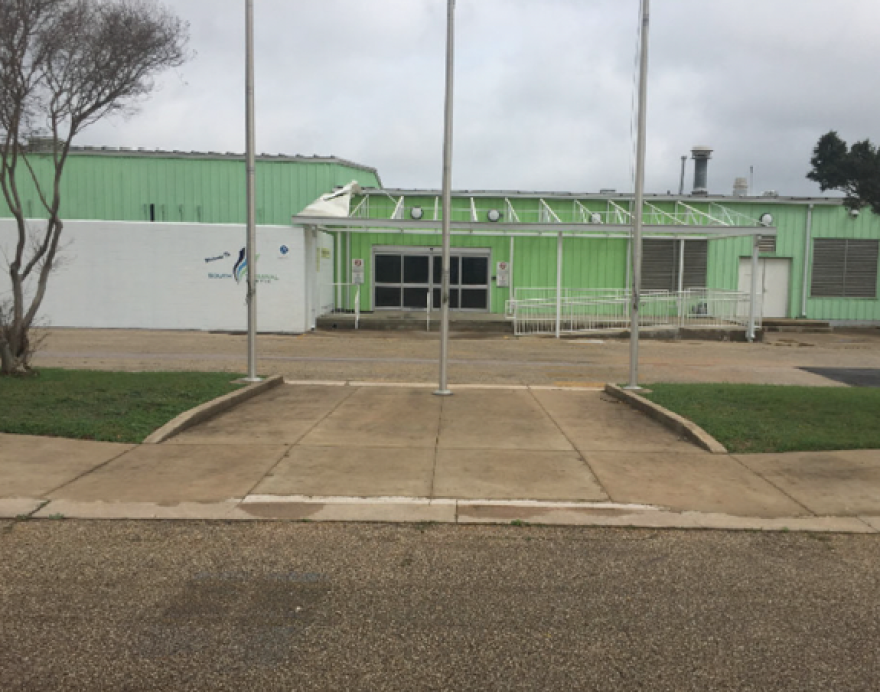 An image of the South Terminal before renovation, showing a green building with corrugated sides.