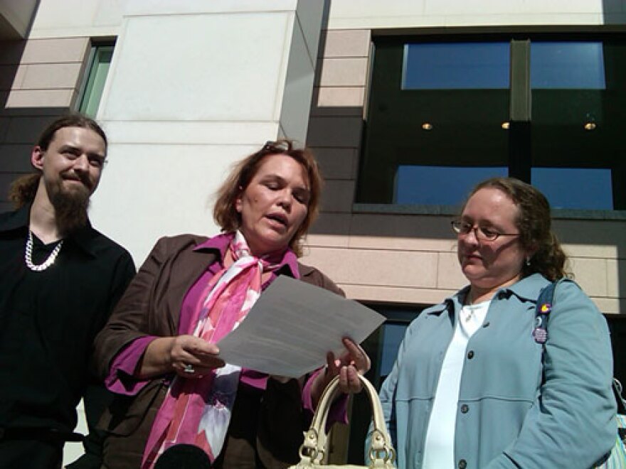 Jason Dow, Laura Brooks and Scottie Wingfield outside the Mecklenburg County Courthouse following their acquital. Photo: Julie