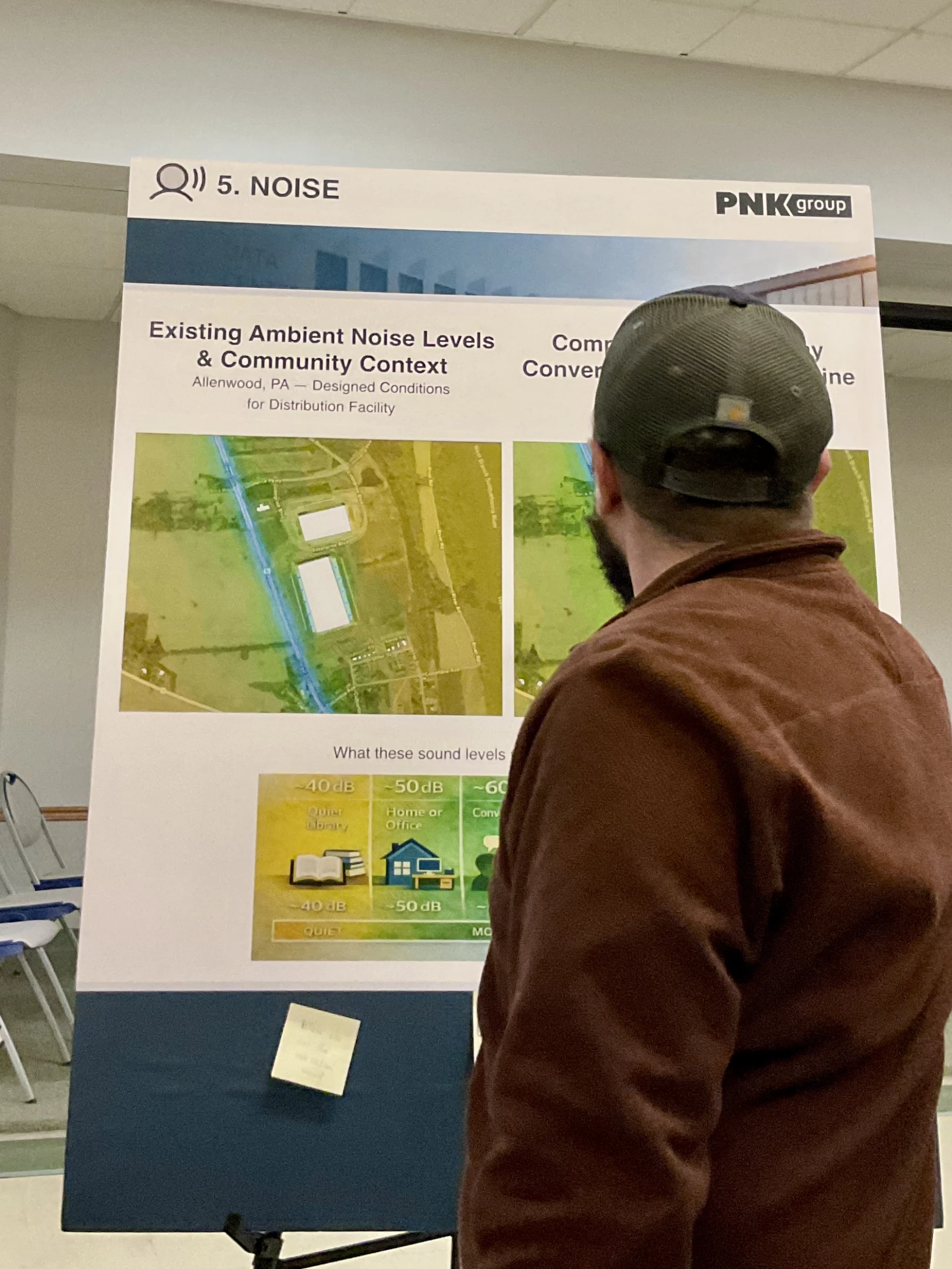 A community member looks at one of the displays during an open house PNK Group held in Gregg Township, Union County, in spring 2026 about its proposed data center. (Anne Danahy/WPSU)