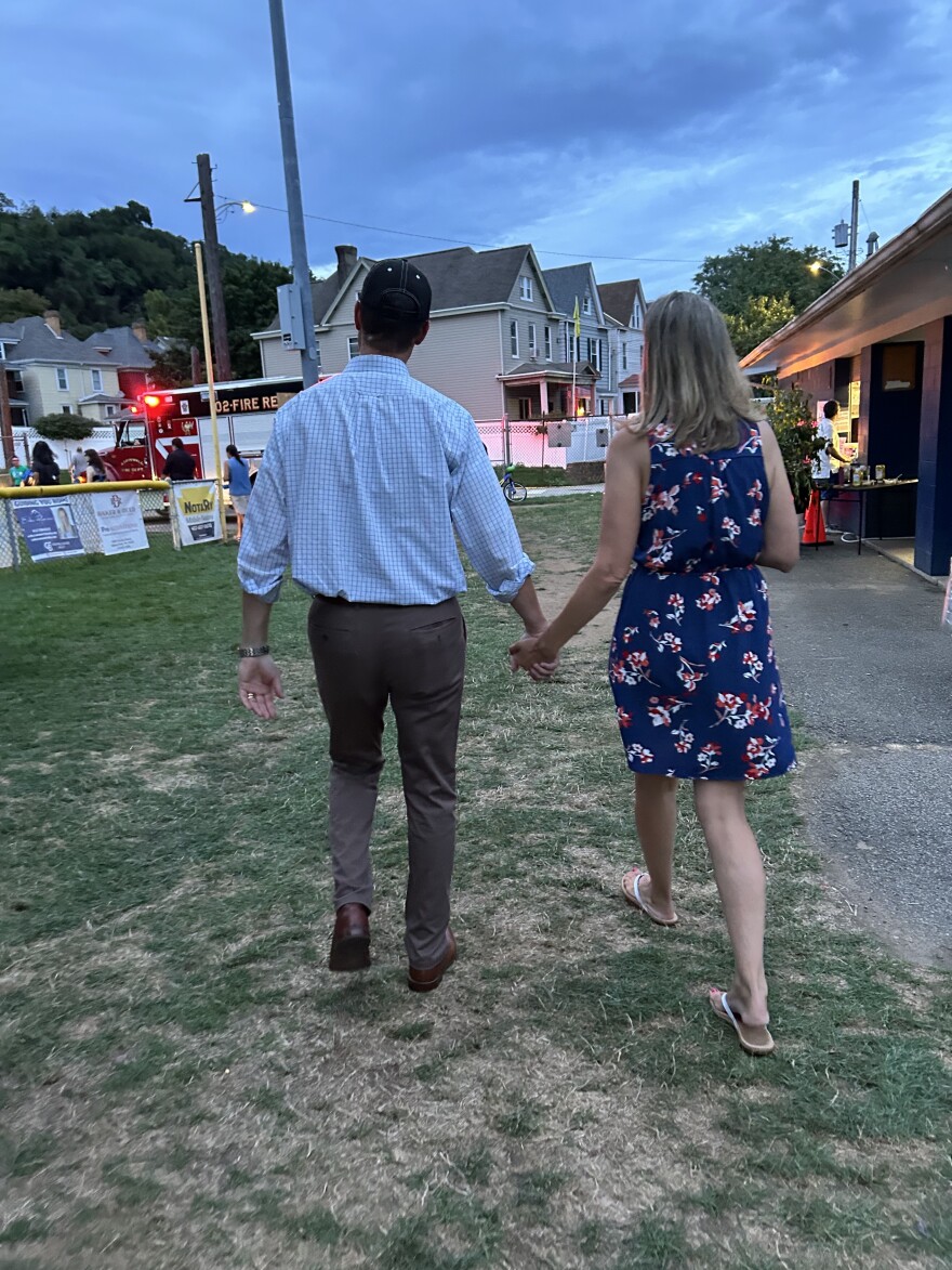 Rob Mercuri walks back to his car with his wife Kelsey after chatting up voters at Aspinwall's Big Night Out back in August.