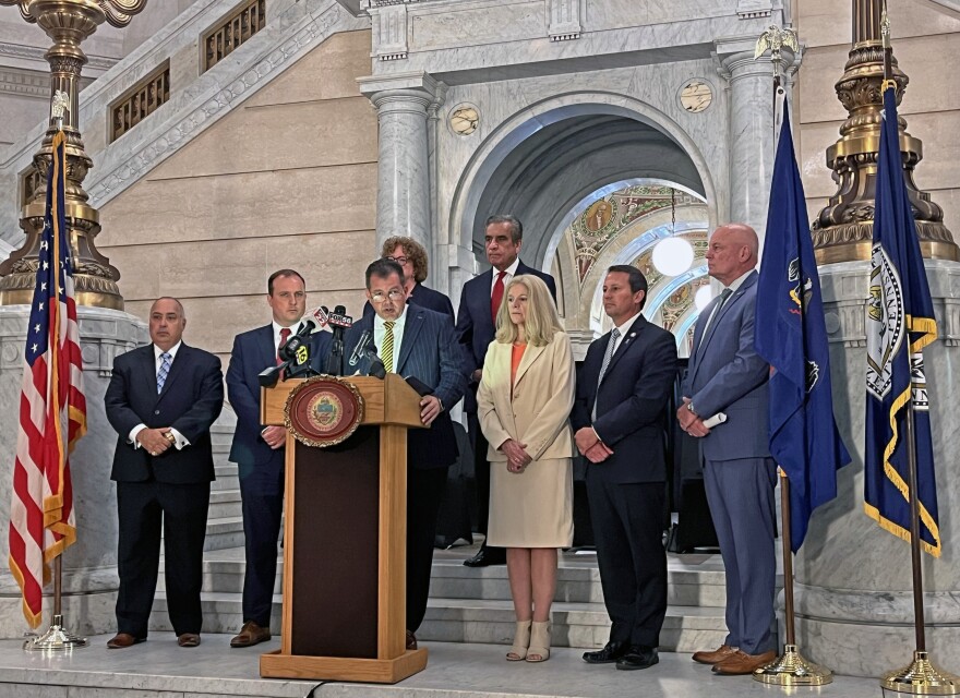 Luzerne County District Attorney Sam Sanguedolce, at the podium, is joined by DAs from around Northeast Pennsylvania on Tuesday, July 21, 2026 for a press conference at his county's courthouse in Wilkes-Barre. They gathered to urge state lawmakers to act on legislation that would remedy felony murder sentencing guidelines in the wake of a state Supreme Court ruling that found life with parole for second-degree felony murder is unconstitutional. Front row, from left, are: Carbon County DA Michael Greek, Lackawanna County DA Brian Gallagher, Sanguedolce, Sullivan County DA Julie Gavitt Shaffer, Wayne County DA A.G. Howell and Schuylkill County DA Michael O'Pake. Back row, from left: Susquehanna County DA Marion O'Malley and Wyoming County DA Joe Peters. 