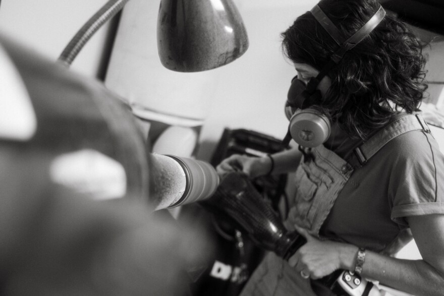Montgomery trims down a prosthetic leg that was causing discomfort for a patient.