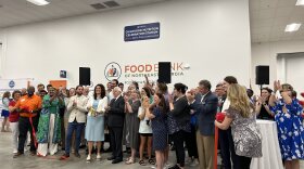 Erin Barger (center) stands with Richard Boone (right of photo), one of the founders of the Food Bank of Northeast Georgia, along with his family as they cut the ribbon.