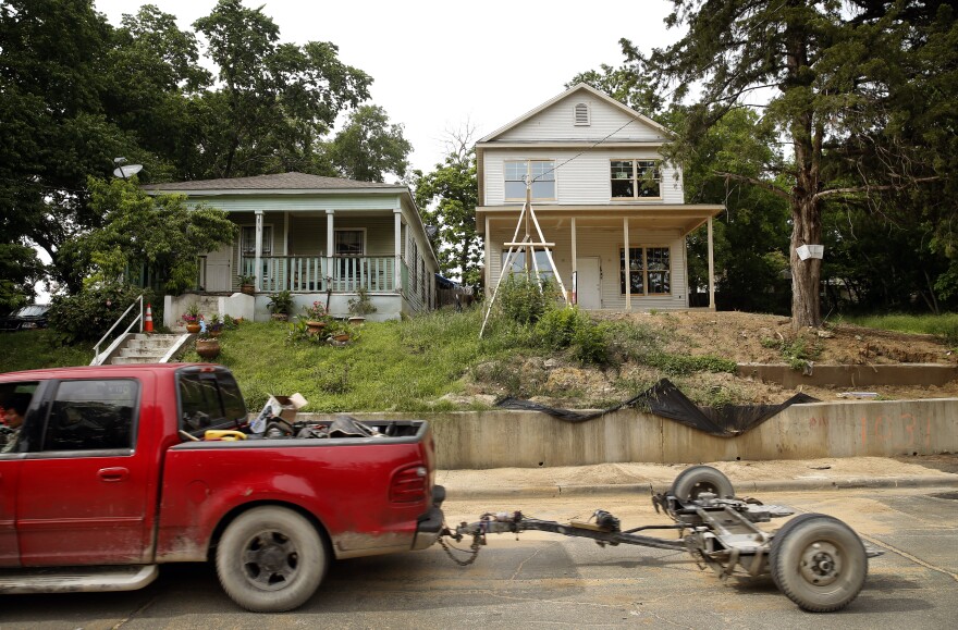 A brand-new house stands next to an old one on Church St. in the Tenth Street Historic District Freedmans Town in Oak Cliff.