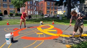 Steed Taylor, an artist in New York City, was commissioned by Real Art Ways, a nonprofit in Hartford, to design and create art titled “No Guns, All Play” at George Day Park, Taylor (at left) completing his work with Chris Pennock, an artist based in New York City and Texas August 10, 2024 in Hartford, Connecticut.