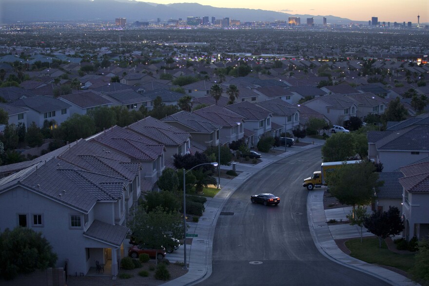 FILE- In this Wednesday, May 29, 2013, file photo a motorist pulls into the driveway in a neighborhood in Henderson, Nev. The country is still sorting through the wreckage of the housing bust, with millions of homeowners still underwater on their mortgages. But the dilemma is that home prices in certain hot markets have soared.(AP Photo/Julie Jacobson, File)