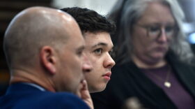 Kyle Rittenhouse, center, looks up and away from the video monitor as footage of him shooting on the night of Aug. 25, 2020, is shown during the trial at the Kenosha County Courthouse.