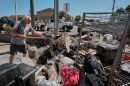 A resident of a storm damaged apartment complex unloads his shovel on a pile of trash while cleaning out his apartment in Pensacola Beach, Florida USA several days after the landfall of Hurricane Isaias on October 11, 2026.
