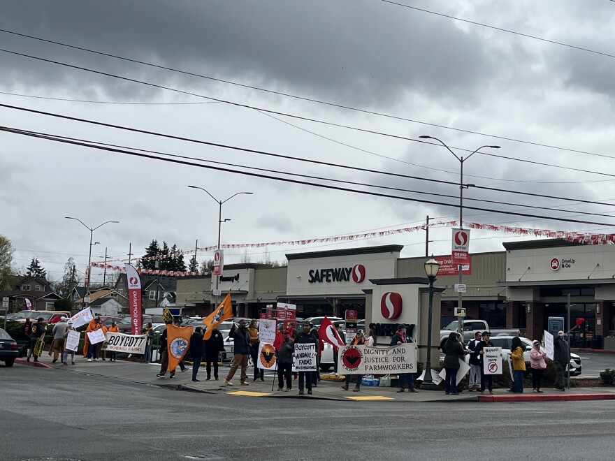 The United Farm Workers and their supporters demonstrated outside a Tacoma grocery store Monday afternoon. They're calling for people to boycott Windmill Farms products. (Credit: Lauren Gallup // NWPB)
