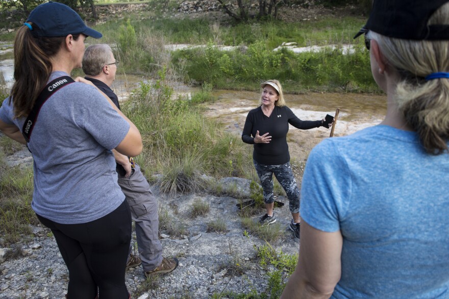  Heather Cadenhead leads a tour of the rock formations behind her home. 