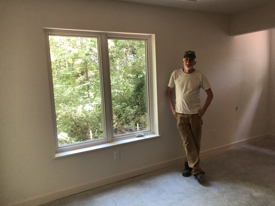 Architectural designer, Michael Cockram, stands in the upstairs main bedroom of Magnolia House overlooking an urban wildlife habitat.