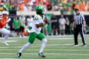 Oregon quarterback Dante Moore prepares to throw a football field.