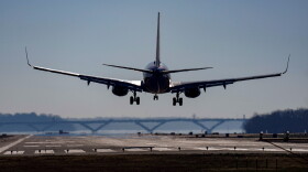 A plane lands on a runway.