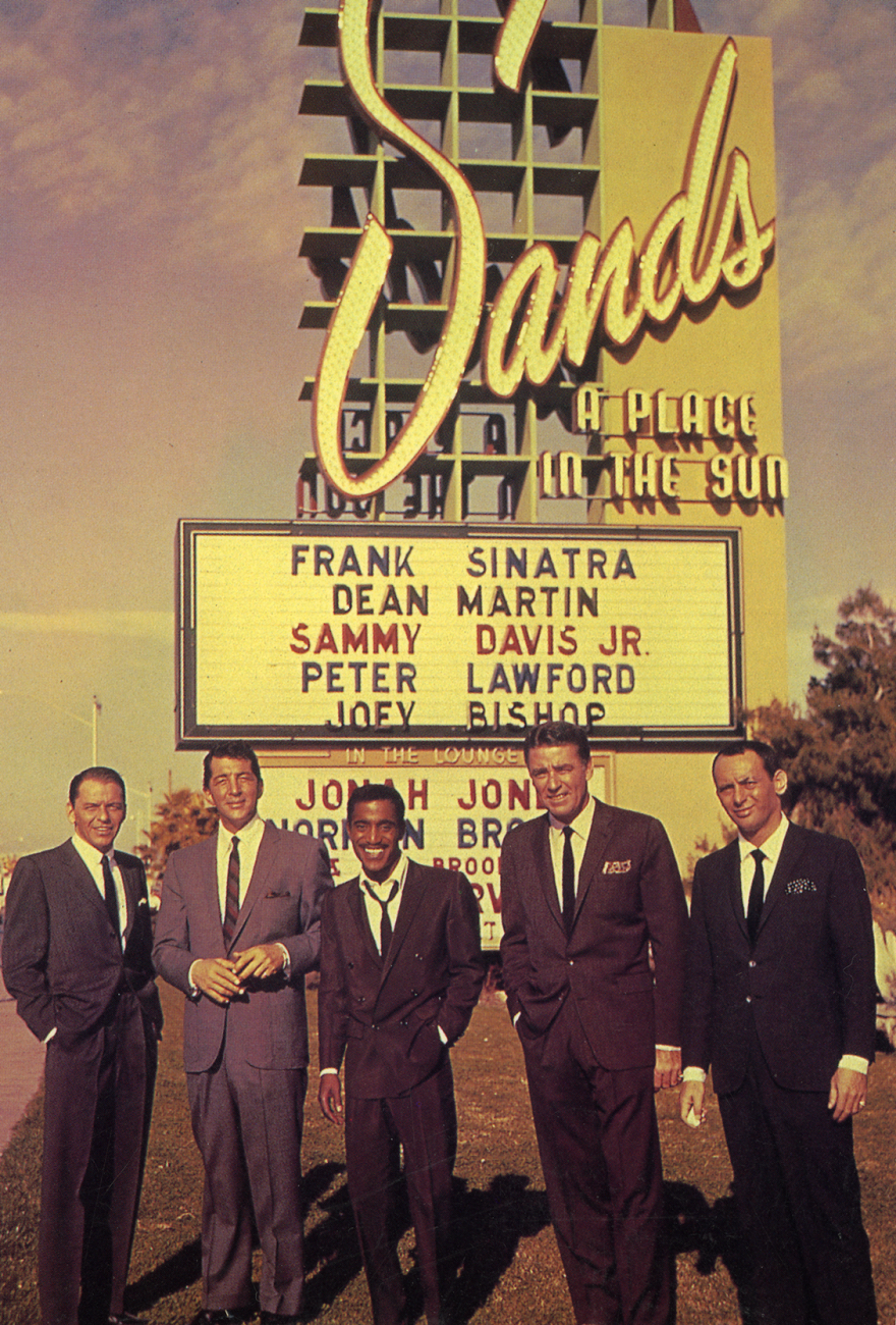 The "Rat Pack" posed in front of the Sands marquee in Las Vegas, Nevada. From left to right: Frank Sinatra, Dean Martin, Sammy Davis Jr., Peter Lawford, and Joey Bishop. Postcard is from Quantity Postcards (1987).