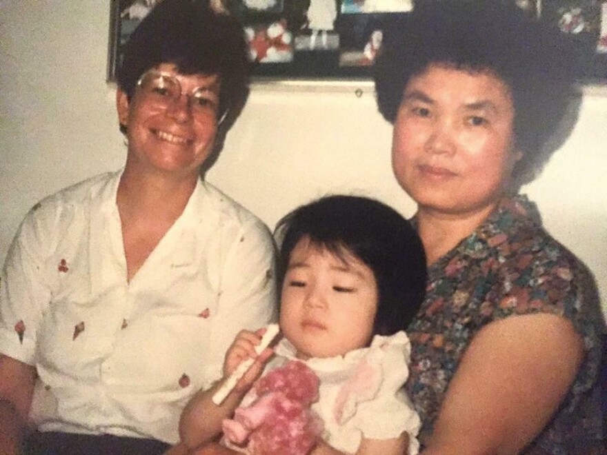 Mia Ives-Rublee (center) with her adoptive mother (left) and foster mother in South Korea (right).