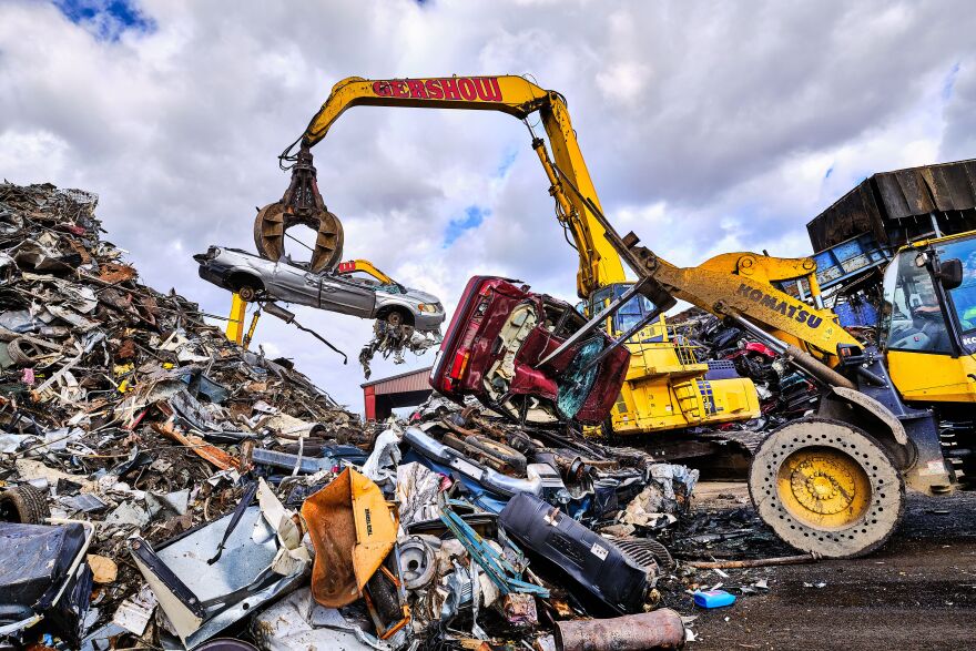 A grappling claw stacks scrapped automobiles in Gershow Recycling Company, Long Island, NY, 2017.