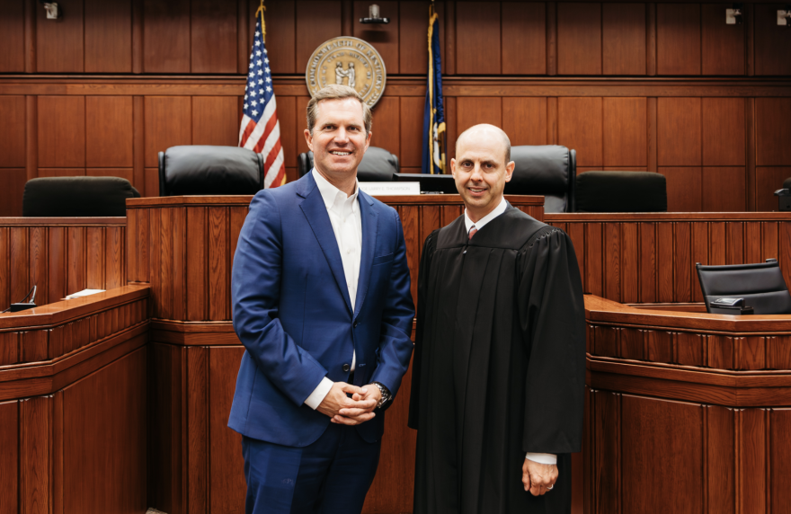 A photo on the campaign website of Judge Will Moynahan features him standing in a courtroom next to Gov. Andy Beshear (left), who is supporting him in his Kentucky Court of Appeals race.