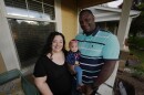 Farra White poses with her 1-year-old daughter, Olivia, and husband Marlon White outside their residence Thursday, May 7, 2026, in Fort Collins, Colorado.