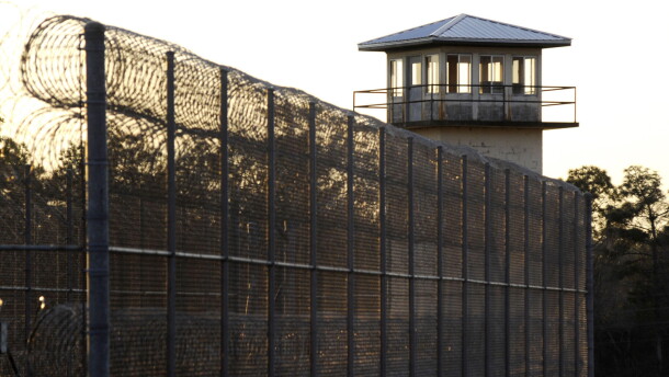 The sun sets behind Holman Prison in Atmore, Ala., on Thursday, Jan., 27, 2022, as the U.S. Supreme Court considered whether to allow the execution of death row inmate Matthew Reeves, convicted of killing a man during a robbery in 1996. (AP Photo/Jay Reeves)