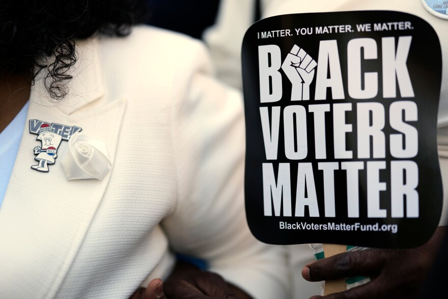 A vote pin is seen on the lapel of Senator Raumesh Akbari, Democrat of Memphis. She holds a sign reading "Black Voters Matter" during a rally after a special session of the state legislature to redraw U.S. Congressional voting maps on Thursday, May 7, 2026, in Nashville, Tennessee. 