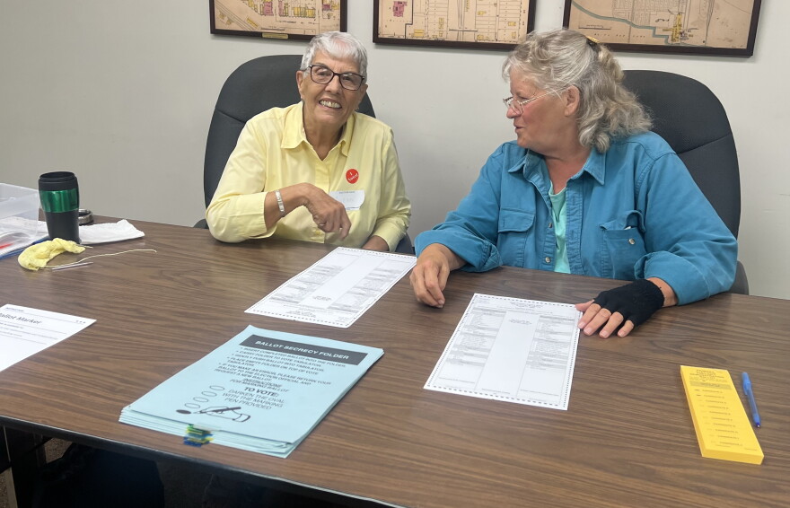 Election judges Gwenn Smith, left, and Kelly Barrett are ready to hand out ballots to voters on Primary Election Day, Aug. 11, 2026, at Deer River City Hall.