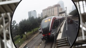 A Metrorail train is reflected in a mirror at the downtown Austin station.  