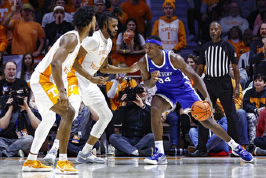 Kentucky forward Oscar Tshiebwe (34) looks for an opening as Tennessee forward Jonas Aidoo (0) and guard Josiah-Jordan James (30) defend during the first half of an NCAA college basketball game Saturday, Jan. 14, 2023, in Knoxville, Tenn. (AP Photo/Wade Payne)