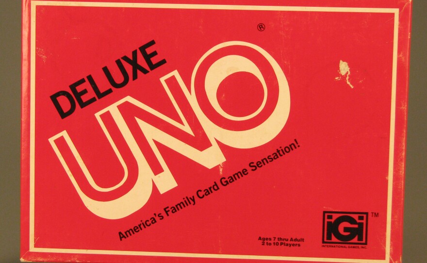 A card-sized red box has black and beige lettering.
