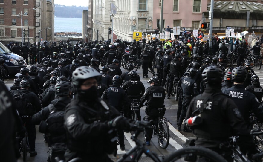 Seattle police officers on bicycles confront protesters during the United Against Hate rally in Seattle last month.