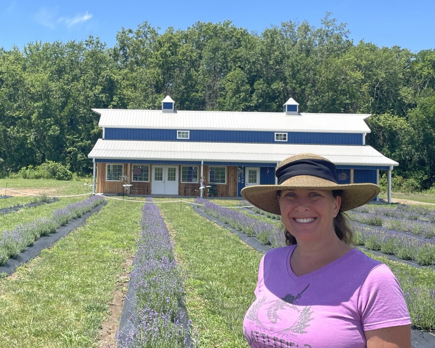 Katie Lockwood stands in front of the barn that sells their merchandise at Battlefield Lavender in Centralia, Missouri.