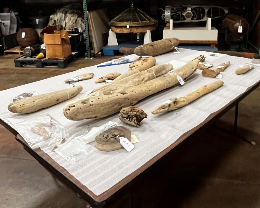 Wooden pieces lay on a table. They are tagged.