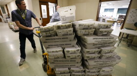 Chet Harhut, deputy manager, of the Allegheny County Division of Elections, wheels a dolly loaded with mail-in ballots, at the division of elections offices in downtown Pittsburgh, May 27, 2020.