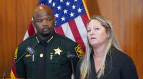 Broward Sheriff's Office Cold Case Unit Sgt. Kami Floyd, right, speaks as Sheriff Gregory Tony looks on during a news conference, Tuesday, June 7, 2022, at the BSO Public Safety Building in Fort Lauderdale, Fla. Authorities announced that they were able to identify and charge a man known as the "Pillowcase Rapist," Robert Koehler, for multiple sexual assault cases in Broward County in the 1980's. (AP Photo/Wilfredo Lee)