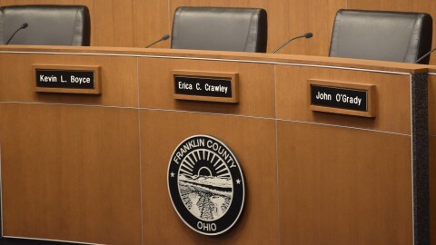 The dais of the Franklin County Commissioners features the names of the three officeholders on October 16 2025: Kevin Boyce, Erica Crawley and John O'Grady.