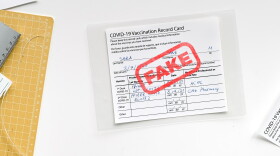 Banner, Fake covid vaccination record card. Covid scams. Forged health certificate with false vaccination record against covid. Blank card, pen, paper knife,laminator. Top view on white.
