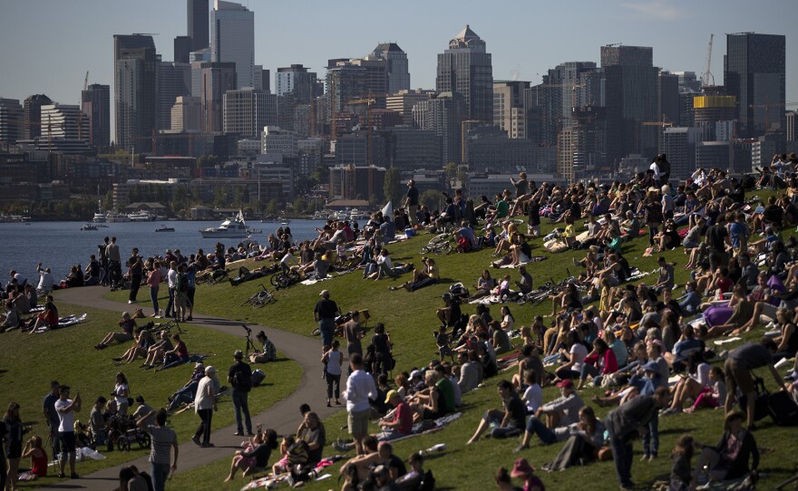 A crowd looks toward the sun during the solar eclipse on Monday, August 21, 2017, at Gas Works Park in Seattle. KUOW Photo/Megan Farmer