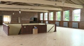 An empty warehouse space with hardwood floors