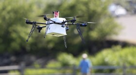 A drone aircraft with a payload of simulated blood, and other medical samples flies during a delivery simulation Wednesday, June 22, 2016, in Lower Township, N.J. (AP Photo/Mel Evans)